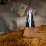 A Metronome on Top of a Walnut Veneer Table in a Drawing Room